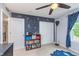 Comfortable bedroom features stylish space themed wall decals, a ceiling fan, and ample closet space at 8556 N Deer Hill Dr, McCordsville, IN 46055