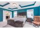 Stylish primary bedroom featuring a tray ceiling, light fixtures, and a sitting area at 8556 N Deer Hill Dr, McCordsville, IN 46055