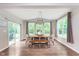 Elegant dining room featuring hardwood floors, large windows, and a stylish light fixture at 8556 N Deer Hill Dr, McCordsville, IN 46055