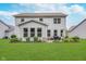 Spacious home with a well-maintained lawn, charming patio, and lush landscaping, perfect for outdoor enjoyment at 8556 N Deer Hill Dr, McCordsville, IN 46055