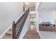 Spacious foyer featuring a view of the dining area and a dark wood staircase at 8556 N Deer Hill Dr, McCordsville, IN 46055