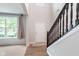 Inviting foyer with hardwood flooring, a staircase featuring dark wood banisters, and plenty of natural light at 8556 N Deer Hill Dr, McCordsville, IN 46055