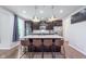 A modern kitchen island with pendant lighting, granite countertops, and seating for four at 8556 N Deer Hill Dr, McCordsville, IN 46055