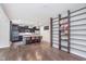 Modern kitchen with a large island, pendant lighting, and dark wood cabinets, adjacent to the dining area at 8556 N Deer Hill Dr, McCordsville, IN 46055