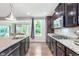Granite countertops highlight the kitchen's modern appliances and open floor plan at 8556 N Deer Hill Dr, McCordsville, IN 46055