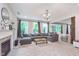 Spacious living room with a fireplace, large windows, neutral decor, and an open concept design at 8556 N Deer Hill Dr, McCordsville, IN 46055