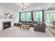 Bright living room featuring a fireplace, large sectional couch, and ample natural light at 8556 N Deer Hill Dr, McCordsville, IN 46055