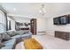 Open-concept living room with an adjacent kitchen, neutral decor, and ample living space at 8556 N Deer Hill Dr, McCordsville, IN 46055