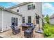 Relaxing patio with comfortable seating, umbrella, and lush landscaping perfect for outdoor enjoyment at 8556 N Deer Hill Dr, McCordsville, IN 46055