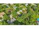 This aerial view features the home set amongst mature trees, nearby homes, and manicured green lawns at 8635 Bishops Ln, Indianapolis, IN 46217