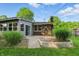 Lush backyard features brick patio, sliding glass door, chimney, and mature plantings at 8635 Bishops Ln, Indianapolis, IN 46217