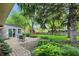 Beautiful backyard patio surrounded by lush greenery and mature trees, perfect for entertaining at 8635 Bishops Ln, Indianapolis, IN 46217