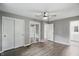 Bright bedroom featuring wood-look floors, a ceiling fan, and double closets at 8635 Bishops Ln, Indianapolis, IN 46217