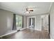 Bedroom with wood floors, closet, ceiling fan, and a window with dark curtains at 8635 Bishops Ln, Indianapolis, IN 46217