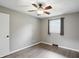Comfortable bedroom featuring a ceiling fan, wood-look floors, neutral walls, and ample sunlight at 8635 Bishops Ln, Indianapolis, IN 46217