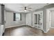 Comfortable bedroom featuring a ceiling fan, mirrored closet, hardwood floors, and soft, neutral walls at 8635 Bishops Ln, Indianapolis, IN 46217