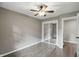 A neutral bedroom features wood-look floors, closet, and ceiling fan with light at 8635 Bishops Ln, Indianapolis, IN 46217