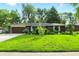 Single-story brick home with a well-manicured lawn and mature landscaping at 8635 Bishops Ln, Indianapolis, IN 46217