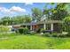 A brick home features a well-maintained lawn, a manicured garden, and mature trees at 8635 Bishops Ln, Indianapolis, IN 46217