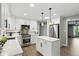 Well-lit kitchen with white cabinets, island with granite counter, stainless steel appliances, and open layout at 8635 Bishops Ln, Indianapolis, IN 46217