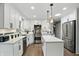 Modern kitchen features sleek white cabinetry, stainless steel appliances, and granite countertops at 8635 Bishops Ln, Indianapolis, IN 46217
