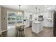 Bright, open kitchen featuring white cabinetry, stainless steel appliances, and a kitchen island at 8635 Bishops Ln, Indianapolis, IN 46217