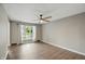 Neutral living room with hardwood floors, a ceiling fan, a window with curtains, and light gray walls at 8635 Bishops Ln, Indianapolis, IN 46217