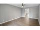 Neutral living room with hardwood floors, a ceiling fan, and an open doorway to another room at 8635 Bishops Ln, Indianapolis, IN 46217