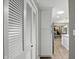 Hallway shot of a pantry with louvered doors and kitchen cabinets with a skylight at 8635 Bishops Ln, Indianapolis, IN 46217