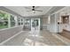 Bright sunroom with tiled floor, multiple windows, and access to the kitchen at 8635 Bishops Ln, Indianapolis, IN 46217