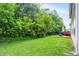 Extensive backyard space featuring a lush lawn, mature trees, and a patio perfect for outdoor activities at 9605 Treyburn Green Way, Indianapolis, IN 46239