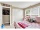 Charming bedroom with plush pink accents, a cozy bed, and a bright window, perfect for relaxation at 9605 Treyburn Green Way, Indianapolis, IN 46239