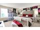Spacious bedroom with a large bed, a display of posters, and ample storage, blending comfort and personal style at 9605 Treyburn Green Way, Indianapolis, IN 46239