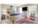 Comfortable bedroom with a decorative bed, soft lighting, and a view of the outdoor scenery at 9605 Treyburn Green Way, Indianapolis, IN 46239