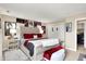 Large bedroom with tufted headboard, displaying decorative items, and offering a cozy and stylish retreat at 9605 Treyburn Green Way, Indianapolis, IN 46239
