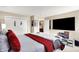 Spacious bedroom featuring a large bed, mounted TV, and adjacent closet, blending comfort and entertainment at 9605 Treyburn Green Way, Indianapolis, IN 46239