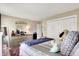 A bright and cozy bedroom featuring soft textures, a stylish dresser, and ample natural light at 9605 Treyburn Green Way, Indianapolis, IN 46239