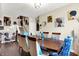 Elegant dining room featuring a dark wood table, artistic wall decor, and stairs to a second floor at 9605 Treyburn Green Way, Indianapolis, IN 46239