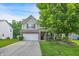Charming two-story home featuring a well-manicured lawn, two-car garage and beautiful brick and siding details at 9605 Treyburn Green Way, Indianapolis, IN 46239