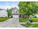 Inviting two-story home showcasing a manicured lawn, charming front garden, and a convenient two-car garage at 9605 Treyburn Green Way, Indianapolis, IN 46239
