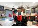Modern kitchen featuring an island, black cabinets, pot rack, and stainless steel appliances at 9605 Treyburn Green Way, Indianapolis, IN 46239