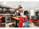Modern kitchen featuring black cabinets, stainless steel appliances, and a red microwave and wine cooler at 9605 Treyburn Green Way, Indianapolis, IN 46239