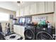 Well-organized laundry room with modern washer/dryer, ample storage, and practical design for efficient chores at 9605 Treyburn Green Way, Indianapolis, IN 46239