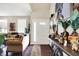Bright living room with hardwood floors, modern decor, and a welcoming front door at 9605 Treyburn Green Way, Indianapolis, IN 46239