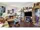 Well-lit living room showcasing hardwood floors, elegant furnishings, and a cozy fireplace at 9605 Treyburn Green Way, Indianapolis, IN 46239
