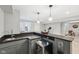 Basement bar with dark countertop, beverage cooler, sink, and pendant lights at 9840 N Anchor Bnd, McCordsville, IN 46055