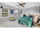 A nicely decorated bedroom with a fun, modern style, ceiling fan, and light-filled windows at 9840 N Anchor Bnd, McCordsville, IN 46055