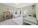 Charming bedroom with dollhouse, plush rug, and bright windows at 9840 N Anchor Bnd, McCordsville, IN 46055