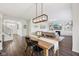 Open-concept dining area with hardwood floors, modern lighting, and access to the living space at 9840 N Anchor Bnd, McCordsville, IN 46055