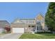 Two-story brick and siding home features a manicured lawn, shutters, and a two-car garage at 9840 N Anchor Bnd, McCordsville, IN 46055